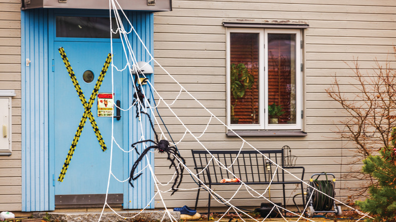 a fake rope spider web outside a house