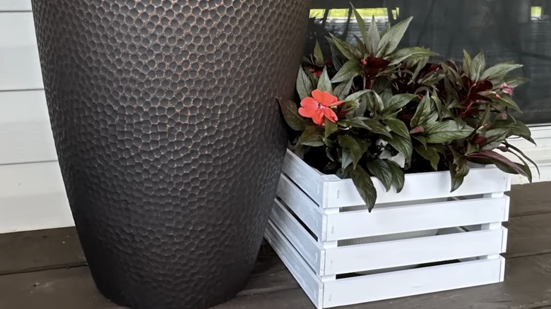 A planter made with paint stir sticks and garden stakes