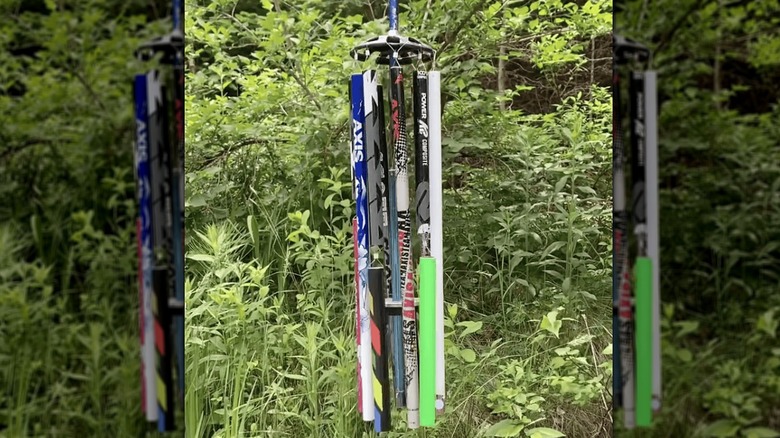 A hanging wind chime made from ski poles