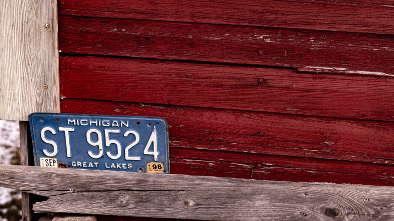 Vintage Michigan license plate against an exterior wall
