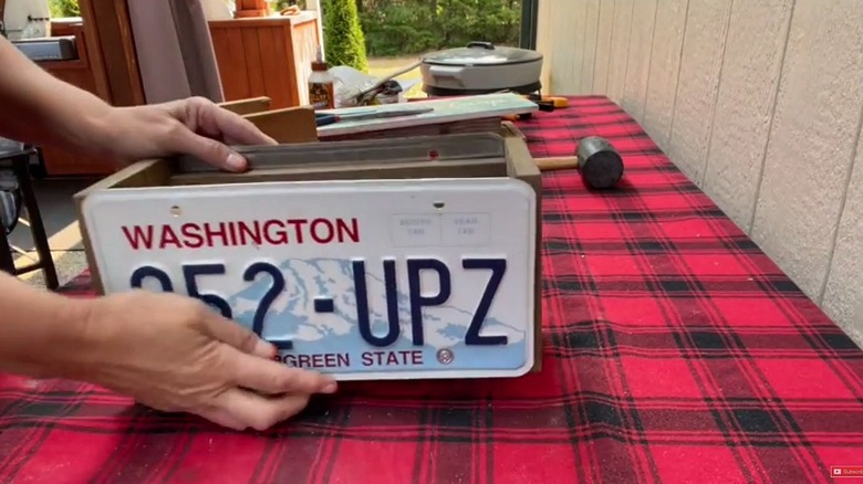 License plate being added to a wooden box