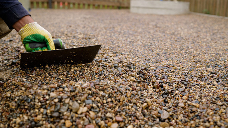 Spreading gravel over top of driveway