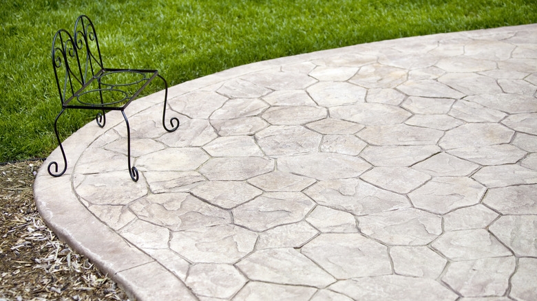 Concrete patio with rod iron chair