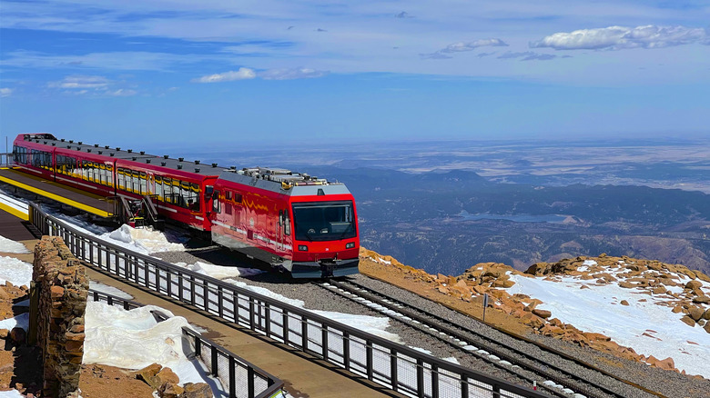 Pikes Peak Cog Railway on tracks going past mountain view