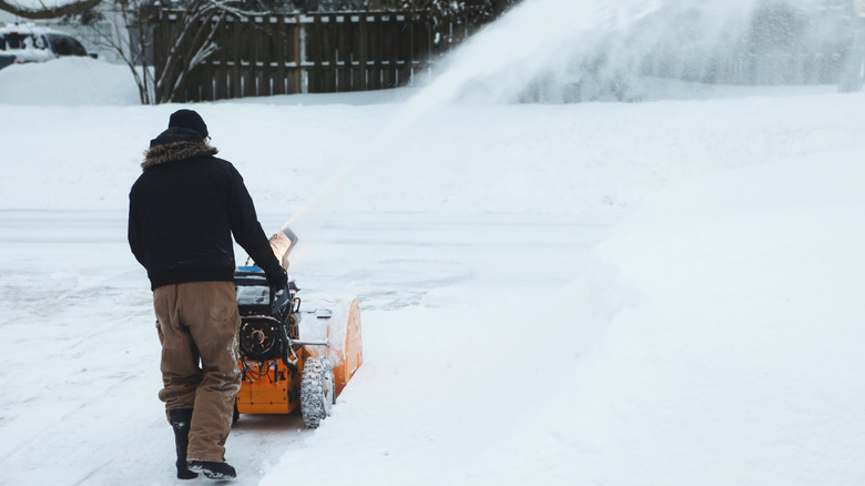 Man uses a snow blower