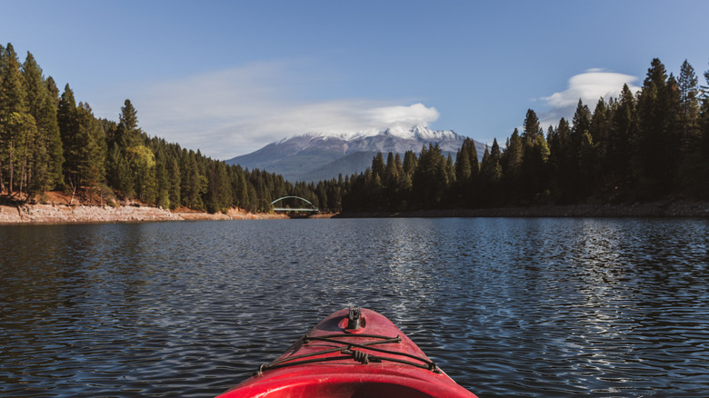 Red kayak facing a placid waterway and distant mountain on Lake Siskiyou