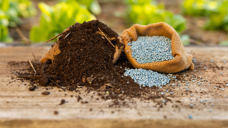 Bag of mulch or compost, and a bag a fertilizer