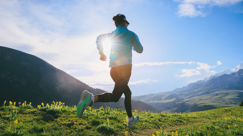 A woman jogs through the wilderness