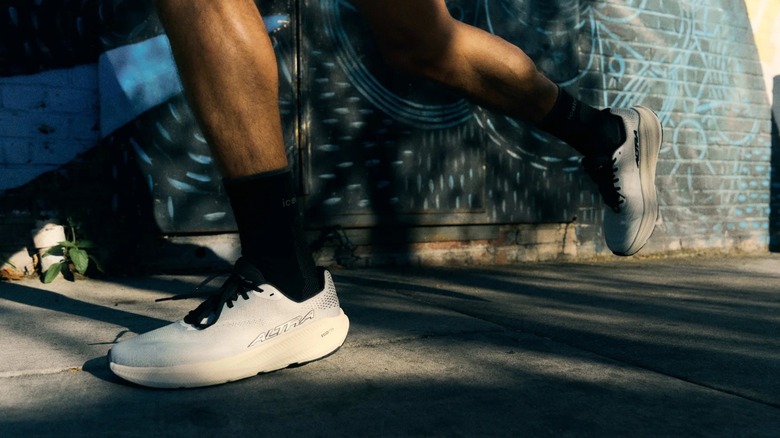 A runner rocking a pair of trail runners in an urban landscape