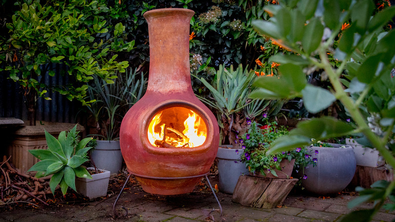 A lit chiminea fireplace on a patio