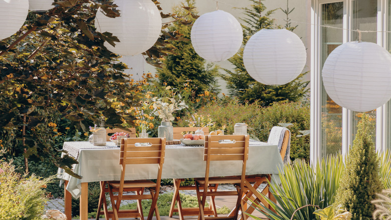 Outdoor dining area with paper lanterns above