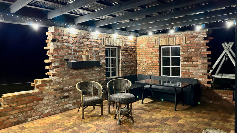 Garden patio with partial brick walls and black beamed ceiling