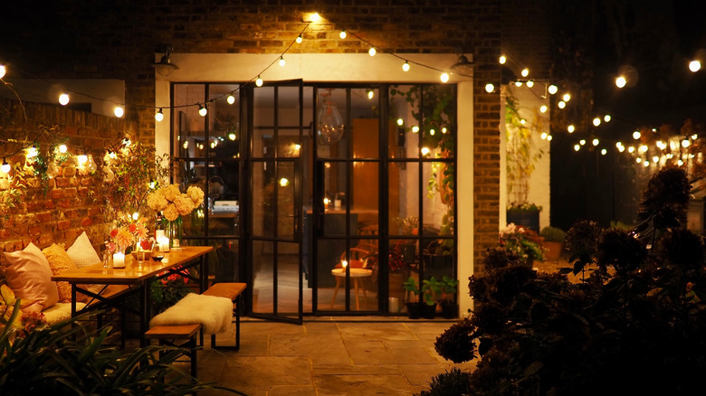 Garden patio lit up with festoon lights