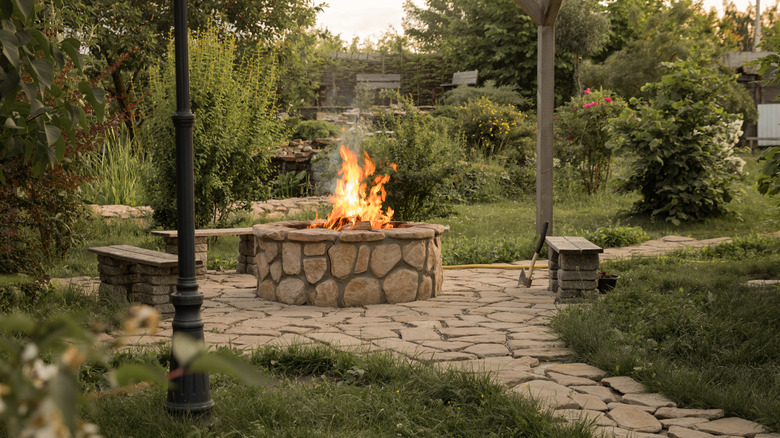 A rock fire pit with flames