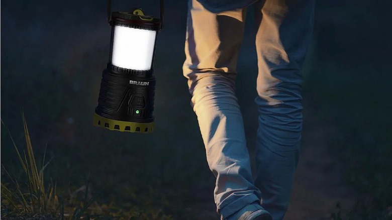Person walking at night with BRAUN lantern