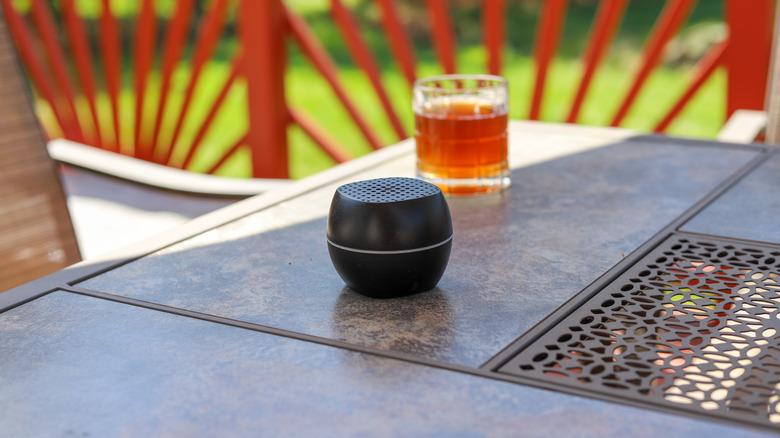 Bluetooth speaker on a patio table during summer