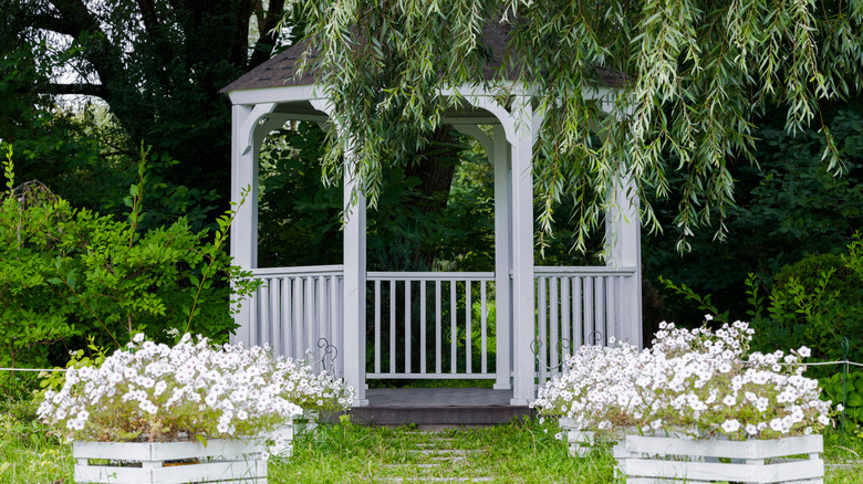 A beautiful garden with a white gazebo