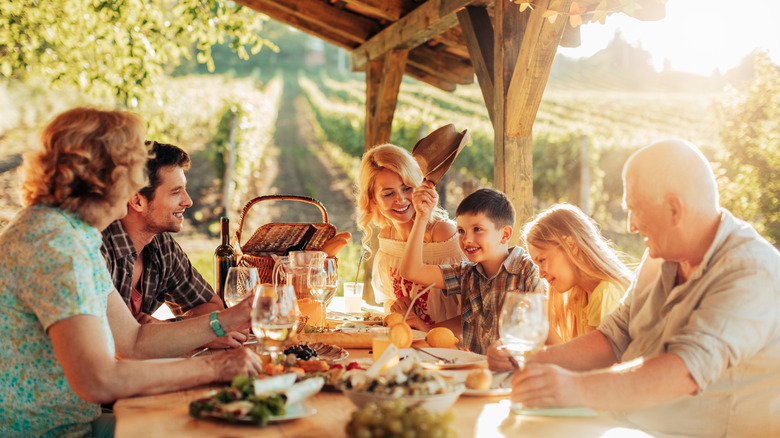 A family enjoying dinner beneath a gazebo