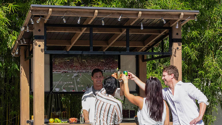 A group of friends enjoying time outdoors with Yardistry's Cantina gazebo