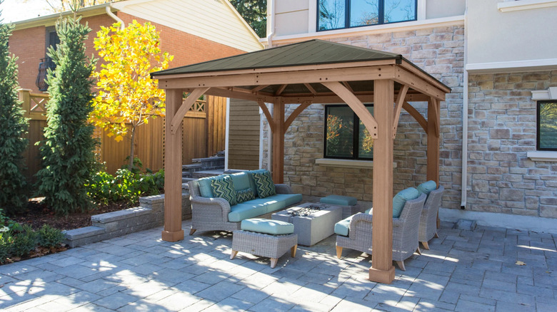 Yardistry's wooden, aluminum-roofed, 12'x12' gazebo in a garden