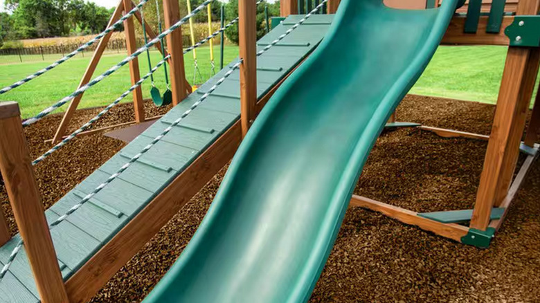 kid's playground with cypress rubber mulch all around it