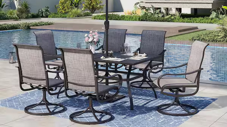 Black metal outdoor dining set by the pool