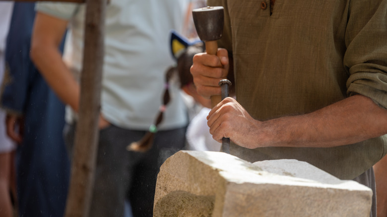 Person chiseling stone