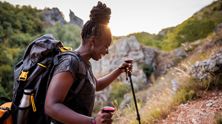 Backpacker hiking with trekking poles