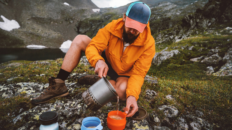 Backpacker making a meal in camp