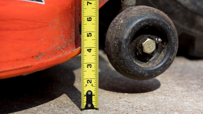 checking the height of lawn mower deck
