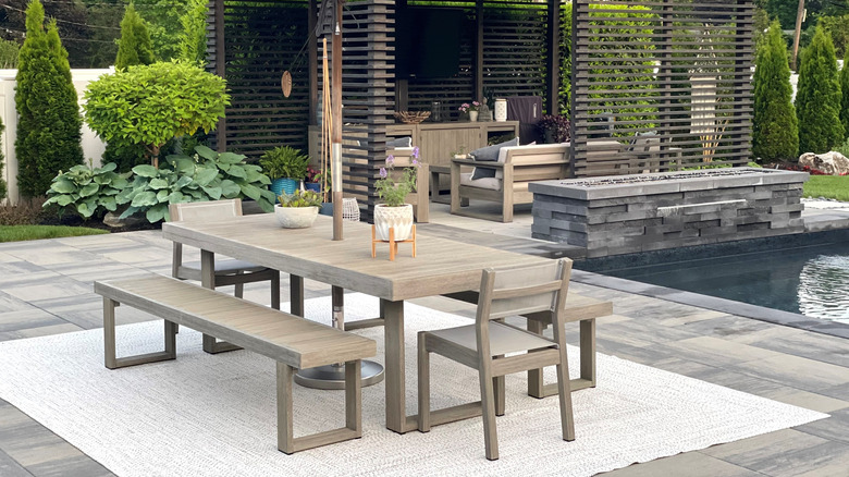 Patio furniture beside outdoor pool