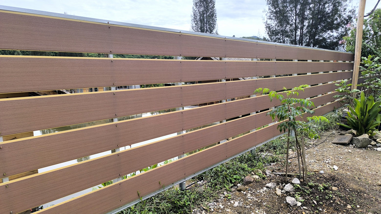 A horizontal fence made from PVC with a somewhat realistic appearance