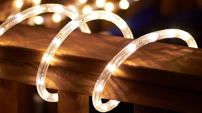 Rope lights wrapped around a deck railing