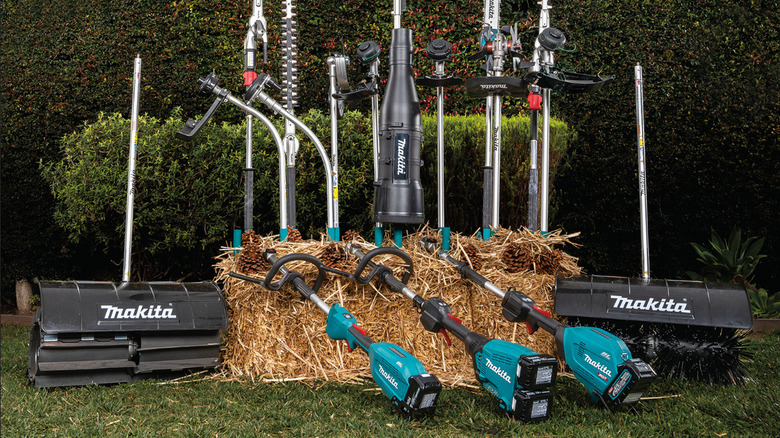 Various Makita Tools propped up behind, around, and in front of a hay bale
