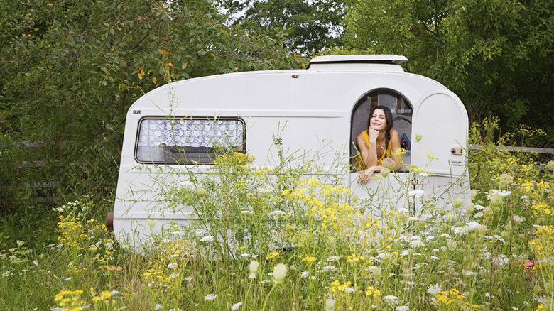 Women looking out the window of her small trailer