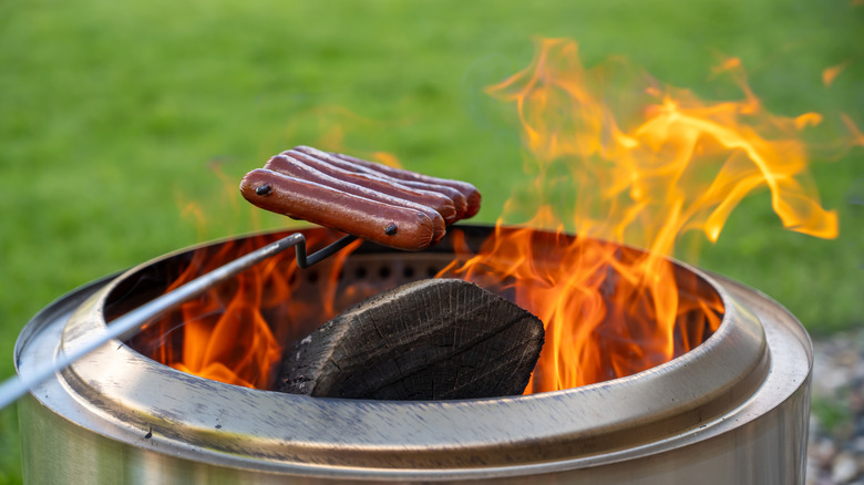Hot dogs roasting over a smokeless fire pit