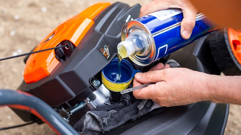 Adding oil to a mower