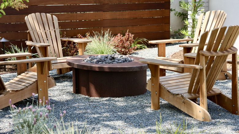 Rustic fire pit and wooden Adirondack chairs