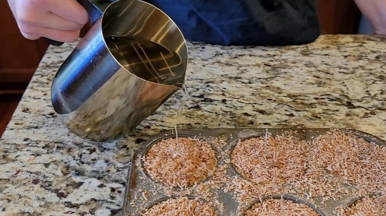 Pouring hot paraffin to make a fire starter