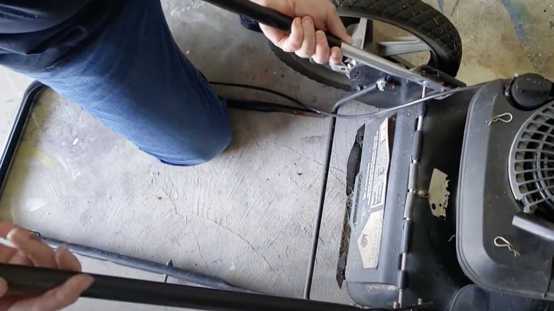 Affixing nee handle to lawn mower