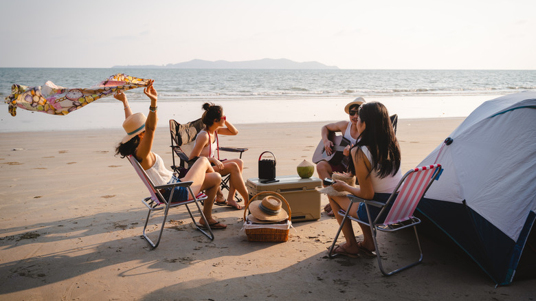 Group of friends camping on the beach