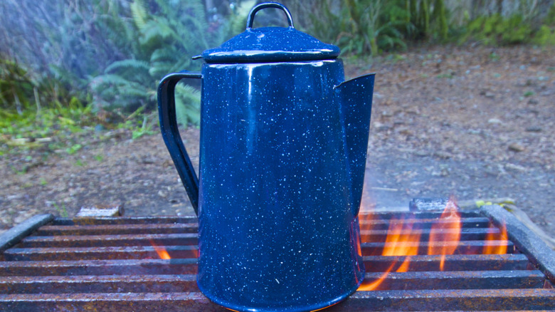 Coffee pot on campfire grate
