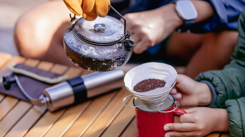Campers making pour over coffee