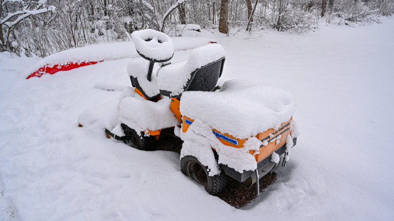 snow covered lawn mower