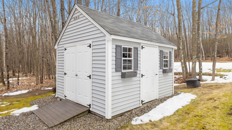 lawn shed surrounded by snow on the ground