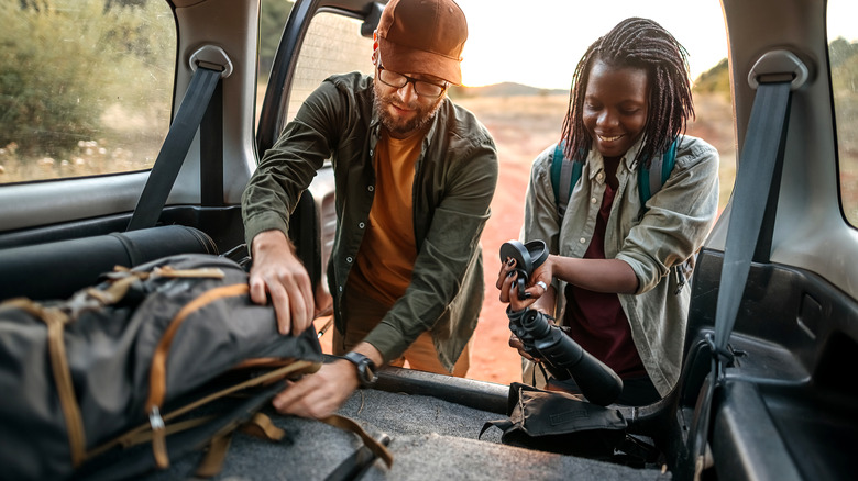 Hikers getting gear out of vehicle