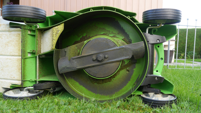 A lawn mower on its side