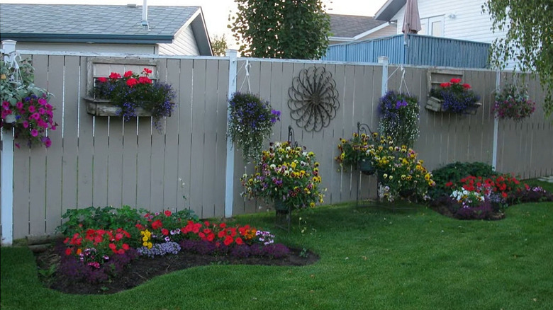 wooden fence with decorations that cover holes and spaces to add privacy