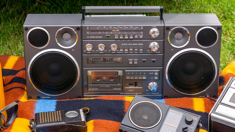 retro boombox on a picnic blanket on the grass