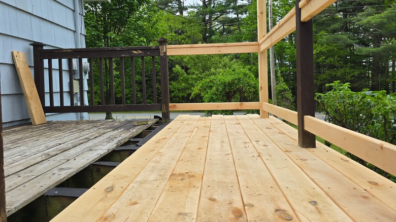A deck in the process of being redone, with old deck on the left and new on the right